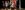 2018_LAIT_I Am England_SevenArts_Photo_MSpadafora Eight young adults stand in a group facing forwards under stage lighting, in front of a Union Jack flag