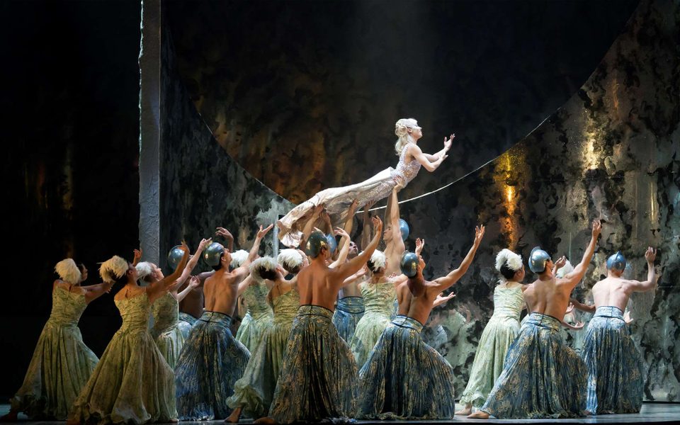 Abigail Prudames as Marilla with Northern Ballet dancers in David Nixon's The Little Mermaid. Photo Emma Kauldhar. (2) (1) Abigail Prudames in a blonde wig and white costume being held up by multiple dancers in skirts