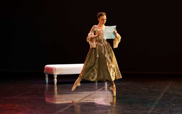 Abigail Prudames as the Marquise in Dangerous Liaisons. Photo Emma Kauldhar Resized Abigail Prudames in period costume on stage holding a sheet a paper