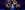 David Breeds and the company of The Curious Incident of the Dog of the Night-Time David Breeds sits in the dar on the floor with a torch in his mouth surrounded by the cast with letters in their hands