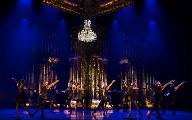 Northern Ballet dancers in Casanova. Ballet dancers dressed in period costumes and masks perform under a chandelier