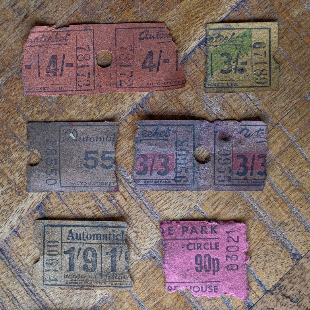 A collection of six old ticket stubs in different colours