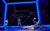 Connor Curren (Christopher) in The Curious Incident of the Dog in the Night-Time A boy in a blue hoodie lays at the front of the stage surrounding by black screens showing images of constellations
