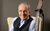 Francis Rossi Francis Rossi smiling, wearing a waistcoat with an acoustic guitar