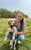 Jessica Davison with her puppy Jessica Davison knelt down holding up her puppy in a field