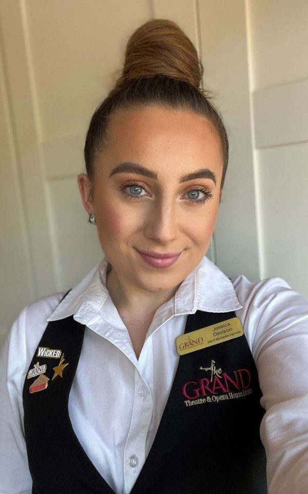 Jessica Davison in a white shirt and waistcoat with her Leeds Grand Theatre name badge