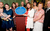 Kay Mellor with The Grand's blue plaque Kay Mellor smiles to the camera, holding The Grand;s blue plaque surrounded by a group of people