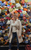 Kirsty Triplett Kirsty Triplett wearing jeans and white shirt smiles to camera against a background of brightly coloured flowers