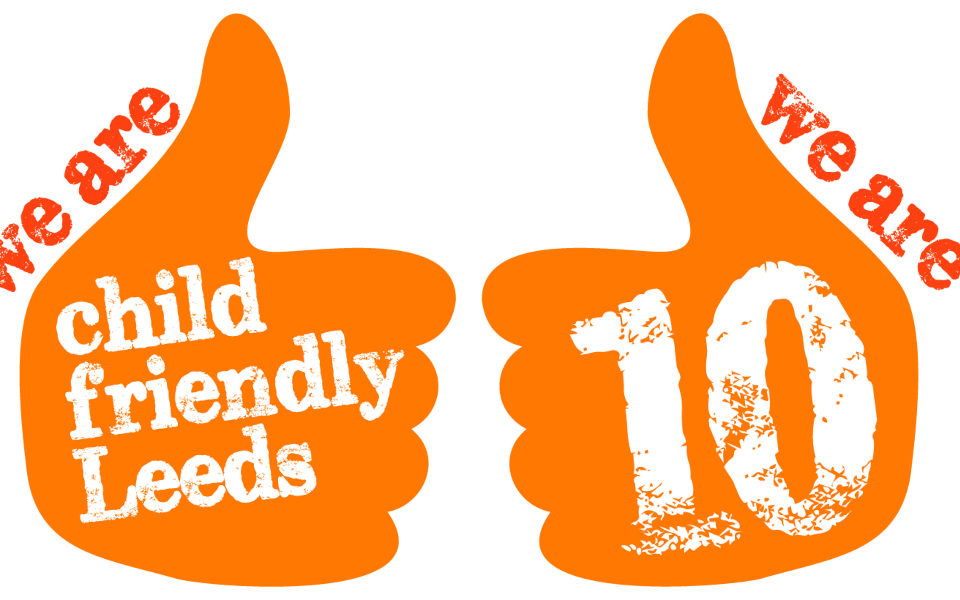 Two orange thumbs up with Child Friendly Leeds and 10 written on them