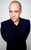 DerrenBrown A portrait of Derren Brown against a grey background