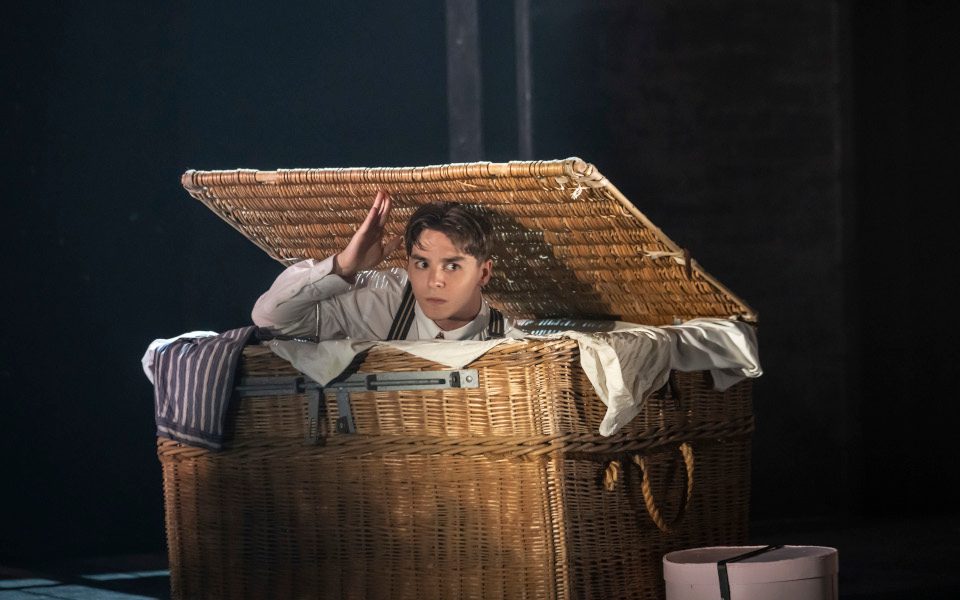 A young person hiding in a wicker basket