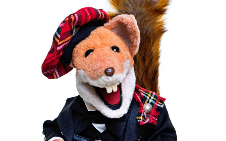 Basil Brush in a red tartan hat and traditional Scottish clothing