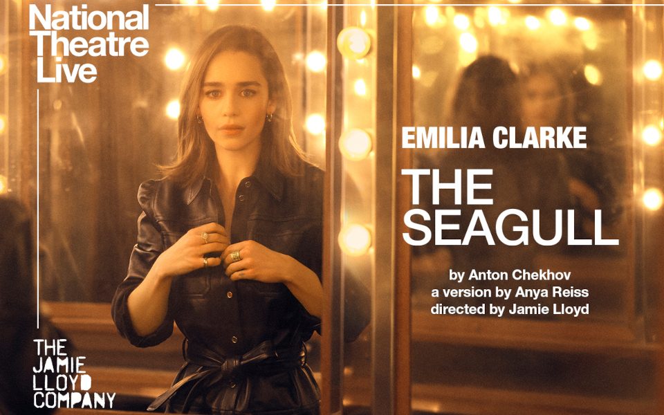 NT Live Seagull poster, Emilia Clarke is looking in a lit-up mirror at her reflection
