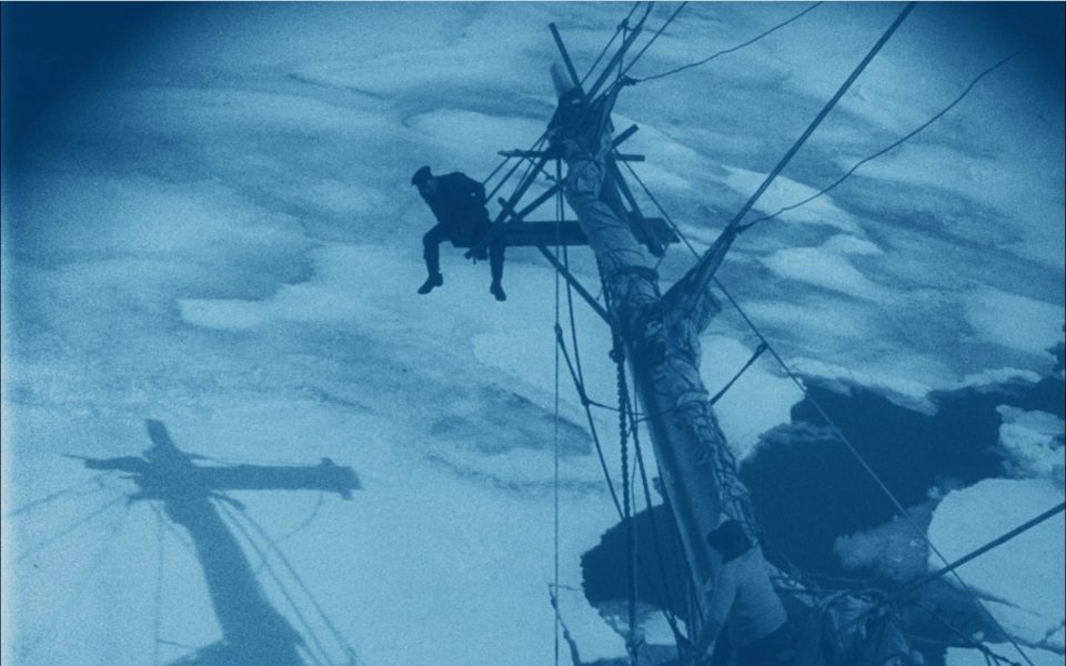 A remastered image from South showing a mast and a man sat on it