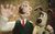 a-grand-day-out-2 A man in a green vest and red tie with a brown and white dog, made out of clay