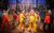 Jason Langley, James Gaddas and Company Two men shaking hands in yellow fishing jackets and trousers in front of the rest of the cast