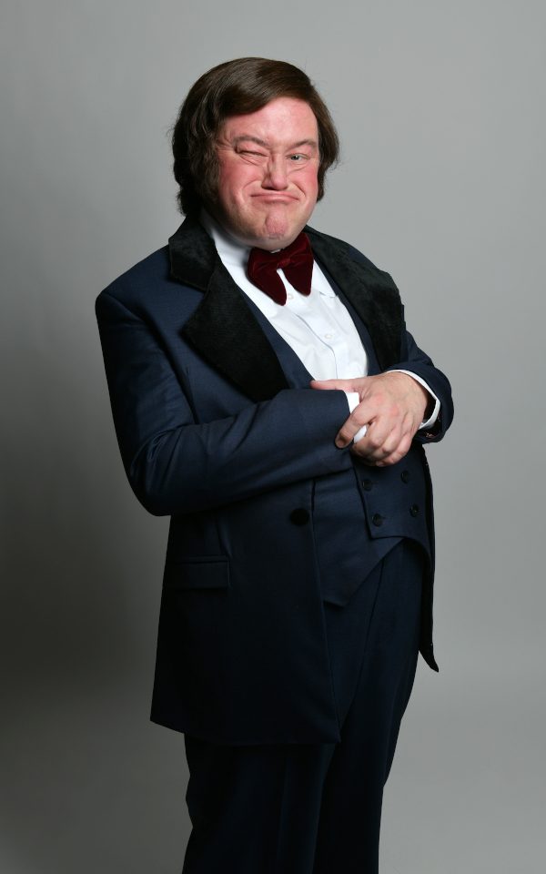 Jon Culshaw as Les Dawson in a suit and a big bow tie