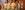 MuchAdoAboutNothingWide Four men in white suits and hats holding luggage for a woman in a check coat