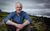 Gordon Buchanan Gordon Buchanan smiling and sat down by a cliff