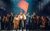 One Day More The cast of Les Mis stand in a group singing beneath a red flag waving