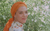 A Door to the Sky (1989) A woman in an orange headscarf in front of green foliage