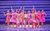 MAMMA MIA! A group of young women in pink costumes walking towards the audience