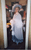 Maureen Kershaw as Mrs Higgins in My Fair Lady A woman in a long dress with a large hat, parasol and a feathery shawl