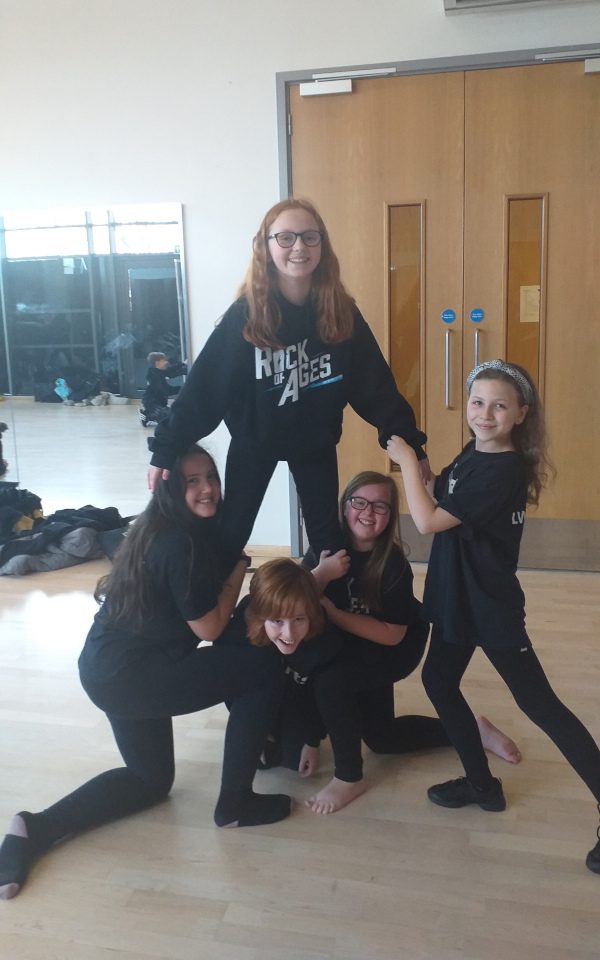 A group of young people making a pyramid