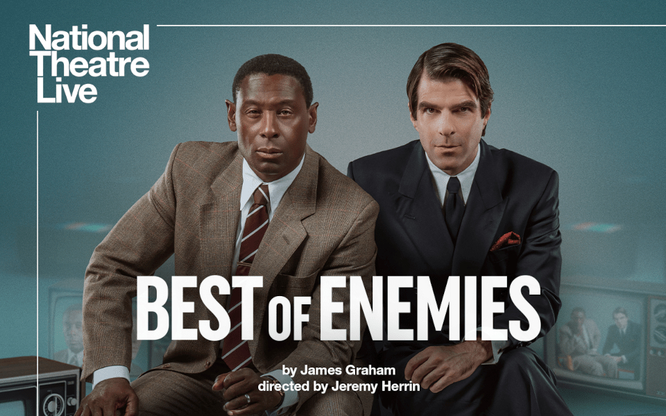 National Theatre: Best of Enemies (Screening) David Harewood and Zachary Quinto sitting side by side next to a tv with them on the screen