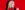 Sara Pascoe Sara Pascoe smiling in front of a red background with a red suit jacket and red lipstick