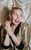 Sara Pascoe Sara Pascoe smiling wearing a gold suit jacket and red lipstick