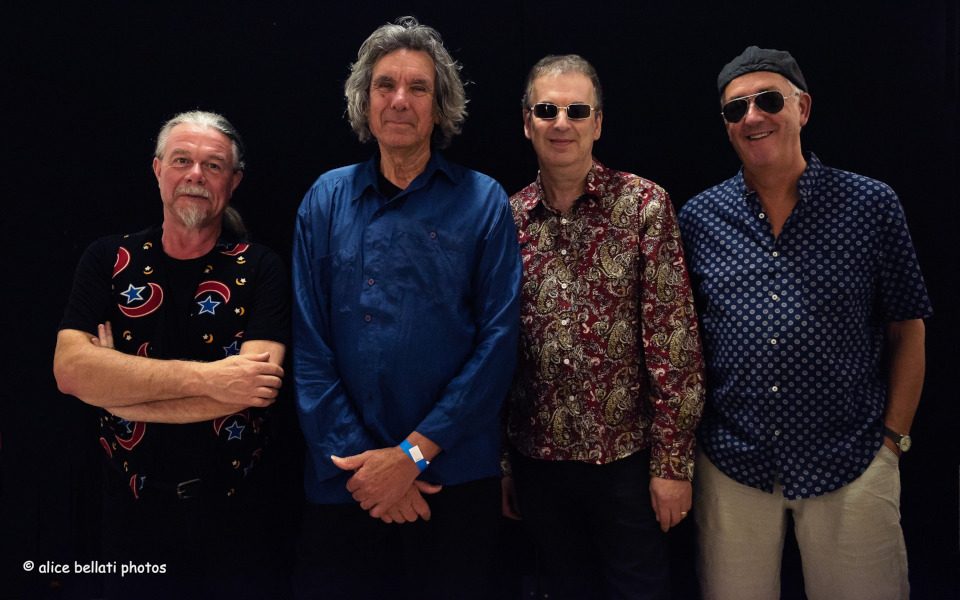 Members of Soft Machine band in front of a black background