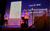 Holocaust Memorial Day 2022 Three performers onstage in front of a letter extract projected on the wall