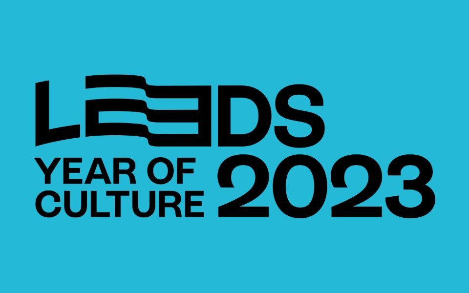 Leeds 2023 Year of Culture logo in black and white against a blue background