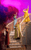 Pride and Prejudice (sort of) Four women in colourful Regency-period costumes spaced out on a white staircase. They sing into microphones and hold their arms in the air. A red cloud of smoke is behind them.