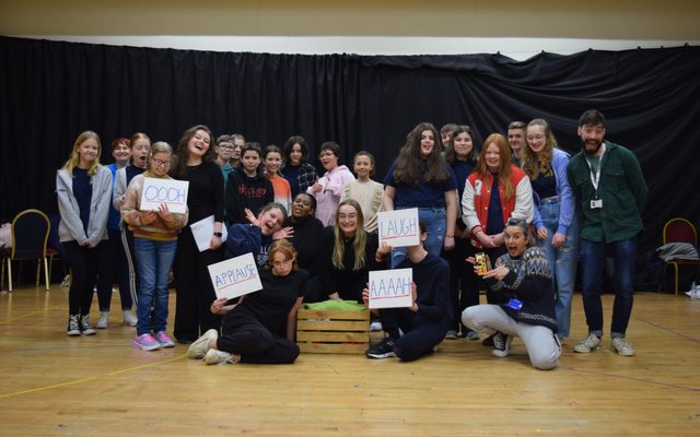 LAIT with Group 2 LGYT and LAIT members pose for a photo while some are holding signs that read; oooh, aaah, laugh and applause