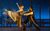 Dominique Larose in The Great Gatsby A man and woman in 1920s costumes facing each other and dancing together. The man holds the woman as she balances in a ballet post