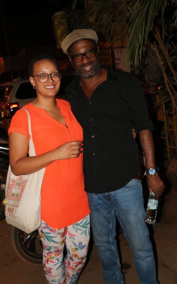 Mosa at the Panafrican Film and Television Festival of Ouagadougou in Burkina Faso. She is standing with Daniel Nganga, a Guadeloupean filmmaker. She is holding a Hyde Park Picture House bag.