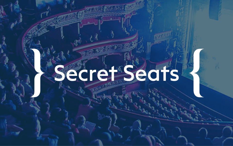 An image of the Leeds Grand Theatre auditorium with a full crowd. The Secret Seats logo is in the centre of the image.