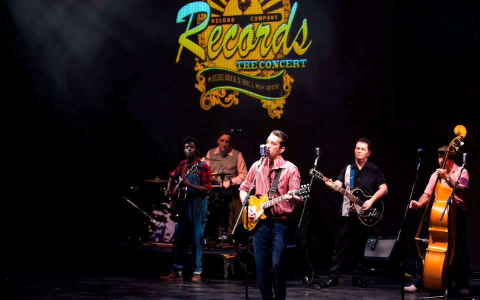 A group performs on stage with various instruments in front of the Sun Records logo.