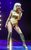 Melody Thornton in The Bodyguard Melody Thornton in a blonde wig singing into a microphone and wearing kneehigh boots and a gold outfit.