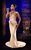 Melody Thornton in The Bodyguard Melody Thornton as Rachel Marron in a light gold full-length dress singing into a microphone