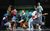 The Commitments A group of men and women in casual clothes singing, playing instruments and dancing around.