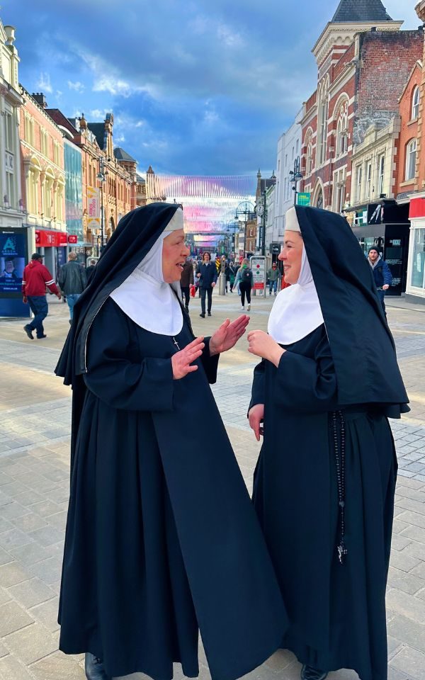 Two nuns from Sister Act gossip on the streets of Leeds. Credit: Aaron Cawood