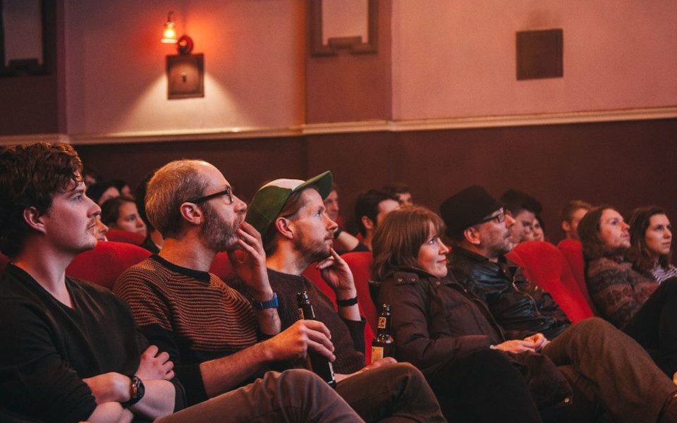 Audience members watching a film at HPPH.