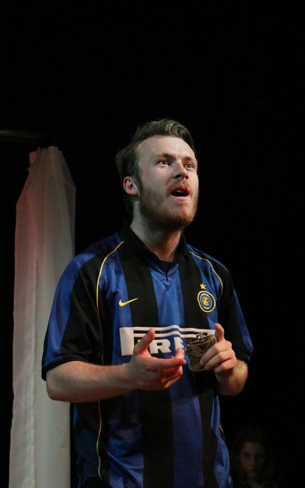 James Lewis-Knight wearing a football jersey and holding a flask.