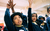 Pupils asking a question. Credit Chris Coote A pair of primary schoolchildren in costume hats put their hands up to answer a question