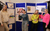 Work Experience A group of work experience students stand in their group and point at their display board of project work