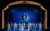 42nd Street Dancers dressed in blue in front of a blue backdrop. There is a hole cut out of the backdrop with a woman standing on a moon.