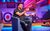 Geoff Norcott Geoff Norcott sits on a purple chair with a large record player and pieces of vinyls in the background.